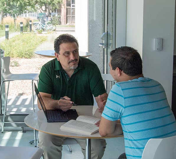 Mark Manzanares speaks to a student